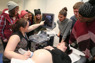 Pictured at the RCSI Open Day are students looking on as Dr Cathy Monteith (Obstetrician at the Rotunda Hospital and RCSI) gives a pregnancy scan to mum-to-be Elaine Spain, who is five months pregnant. More than 350 students from second-level schools throughout Ireland got a taste for life as a medical, pharmacy and physiotherapy student at the RCSI Open Day. At this annual event, Leaving Certificate students also got to experience what it is like to work as a healthcare professional in each of these fields by witnessing a live operation and a real-life pregnancy scan, among many more activities.